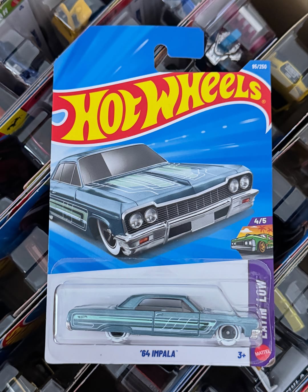 Hot Wheels '64 Impala toy car in packaging on a blurred background