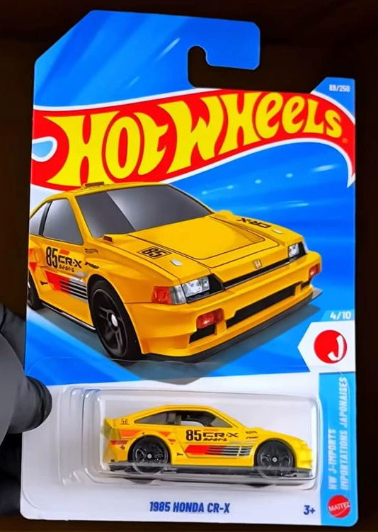 Hot Wheels 1985 Honda CR-X toy car packaging on a dark background