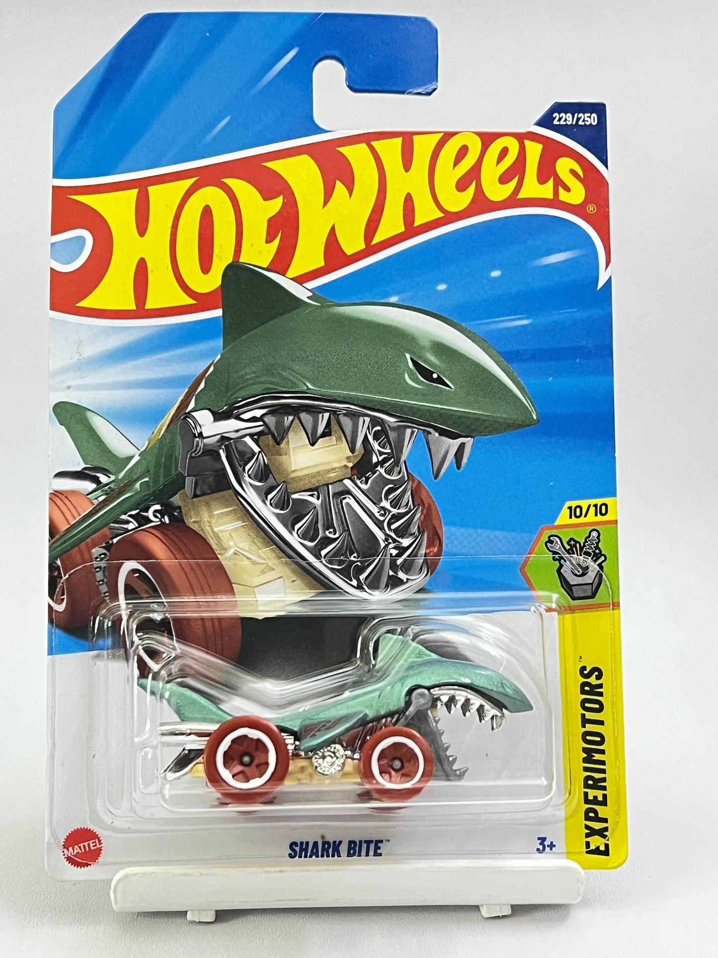 Hot Wheels shark-themed toy car in packaging with blue and yellow design