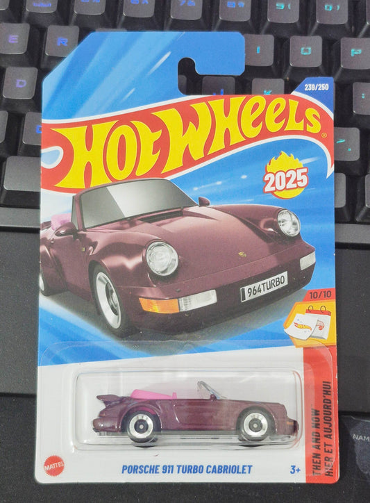 Hot Wheels Porsche 911 Turbo Cabriolet toy car in packaging on a keyboard